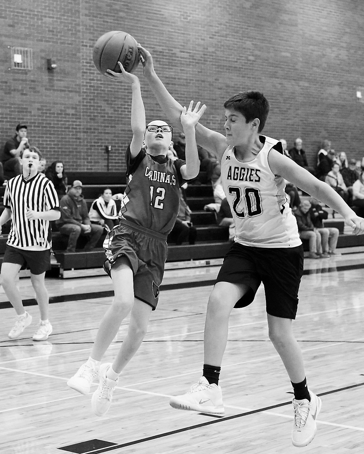 Aksel Bredeson drops in a right handed lay-up in Park River on Nov. 6. Photo by Larry Stokke. Chet Ottem drives in for a layup and gets fouled, sending him to the free throw line in the game against the Aggies. Photo by Larry Stokke.