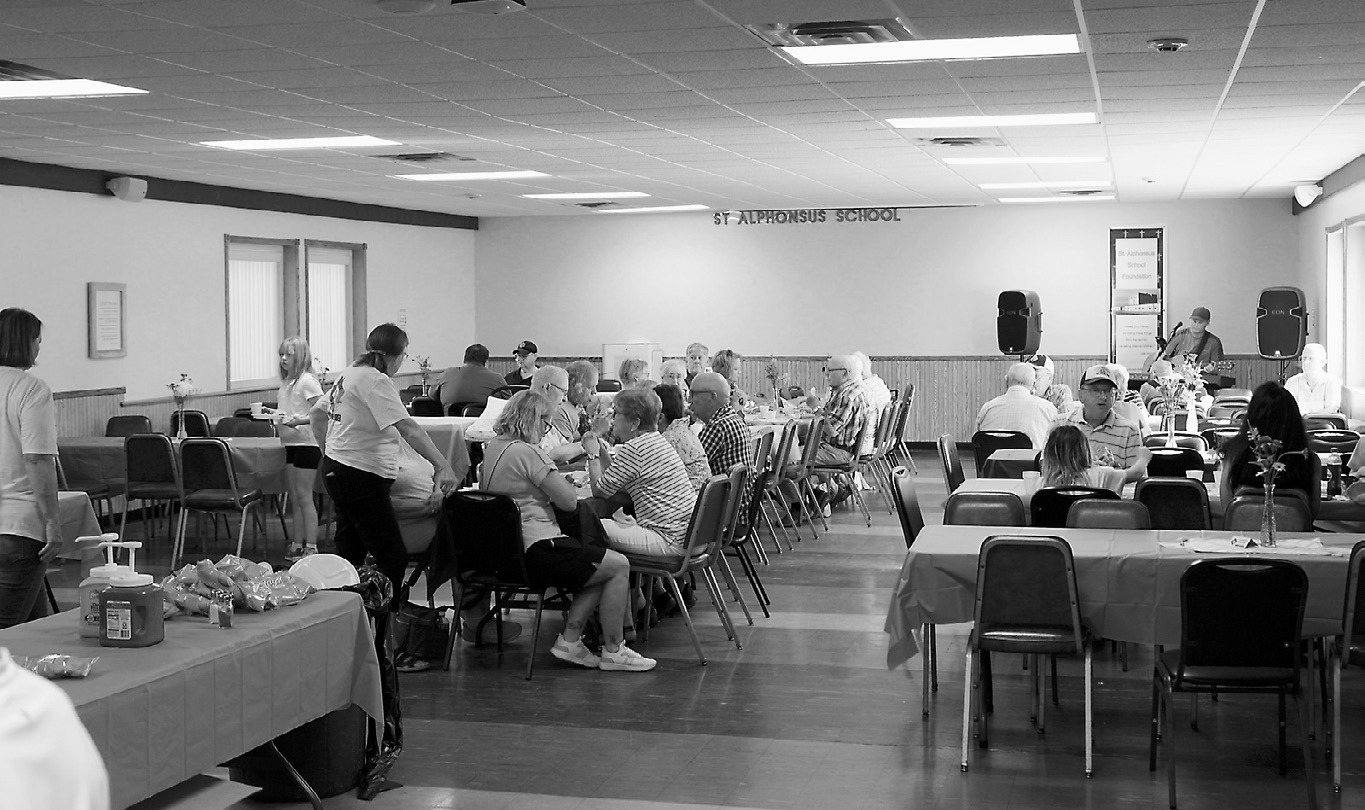 Hotdogs and hamburgers were fresh off the grill and food was accompanied by live music. Photo by Larry Stokke.
