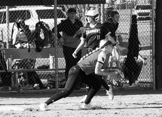 McKenna Schneider puts out the base runner and looks to throw the ball to home plate. Photo by Larry Stokke.