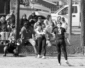 Meredith Romfo drives the ball into the outfield. Photo by Larry Stokke.