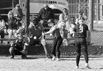 Tallia Johnston eyes the ball and connects for a base hit. Photo by Larry Stokke.