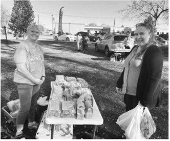 Shoppers browse locally made goods and baked treats during the Langdon Farmers Market, supporting area vendors and enjoying a fall day in the community.