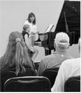 Brooke Gemmill participates in a master class led by Dr. Helen Marlais during the Popplers Music Competition in Grand Forks.