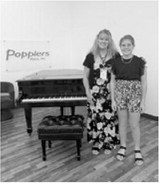 From left, piano teacher Lisa Schuler and student Brooke Gemmill pose together during the Popplers Music Competition in Grand Forks.