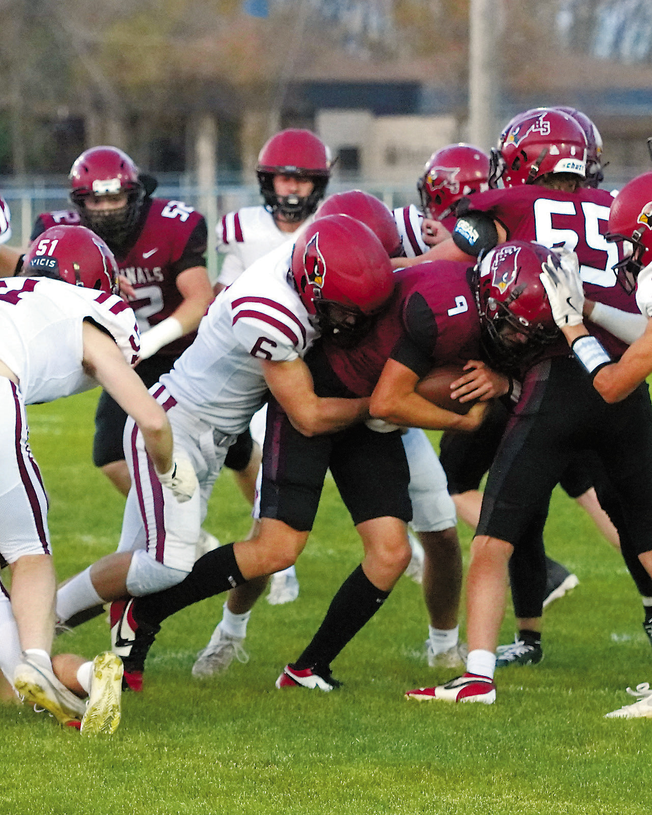Braxton Lindseth and his teammates wrap up Carrington's quarterback to stop any yardage gain. Photo by Larry Stokke.