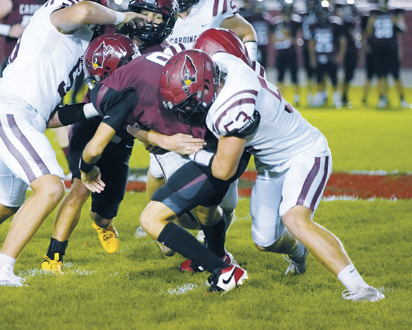 Colton Hein with help from his teammates stops any forward yardage gain by a Carrington ball carrier. Photo by Larry Stokke.