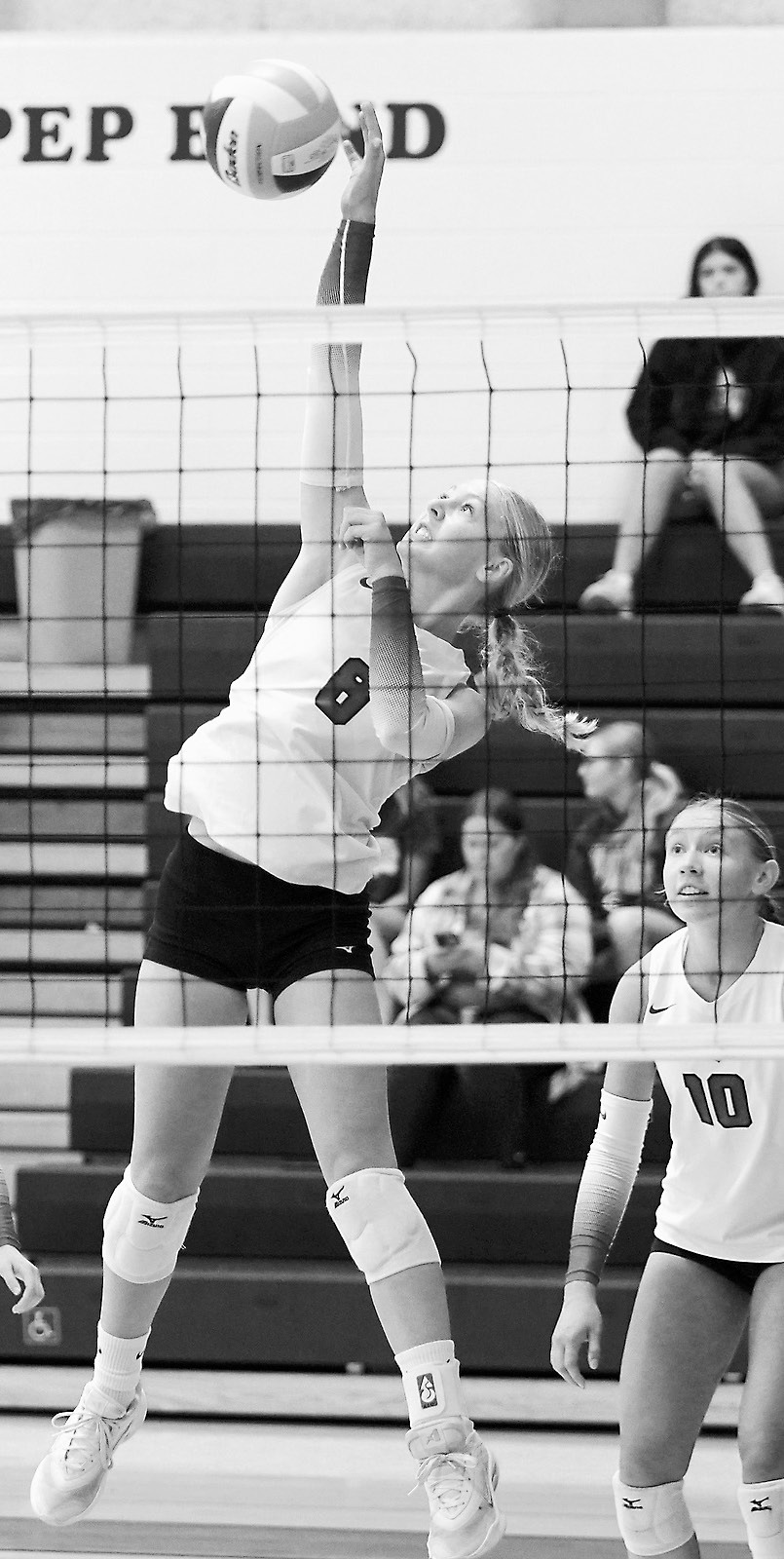 Hilary Haaven spikes the ball over the net in Thompson for a point. Photo by Larry Stokke.