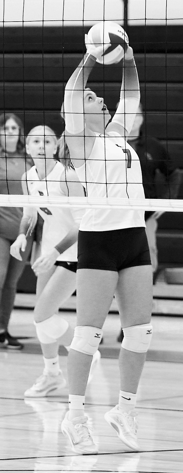 Liv Prouty eyes the ball as she sets it high to a teammate. Photo by Larry Stokke.