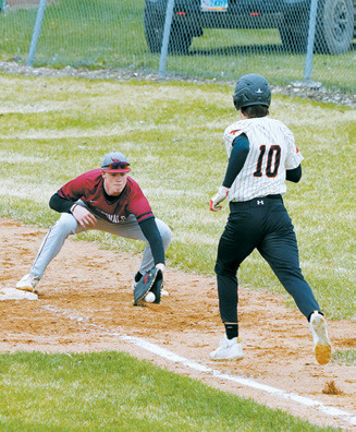 Dawson Hein puts out Midway-Minto's Jack Lane at first base in the Cardinals’ win. Photo by Larry Stokke.