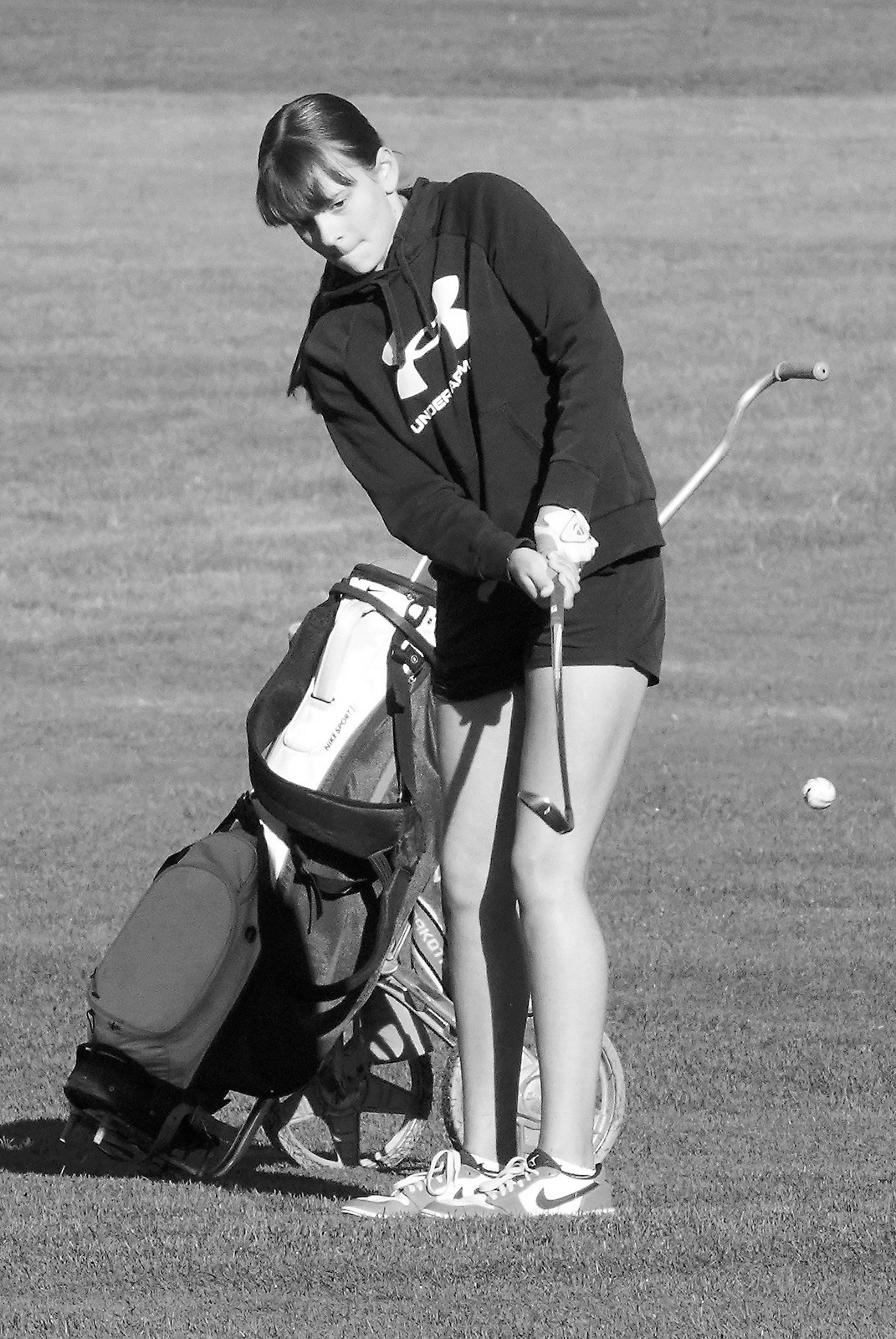 Lily Zimmer with a chip shot up onto the green in Lakota on Aug. 22 where she finished the day with a score of 103. Photo by Larry Stokke.