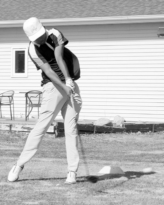 Gabe Symington tees off at the Langdon Invitational on April 25. Photo by Larry Stokke.
