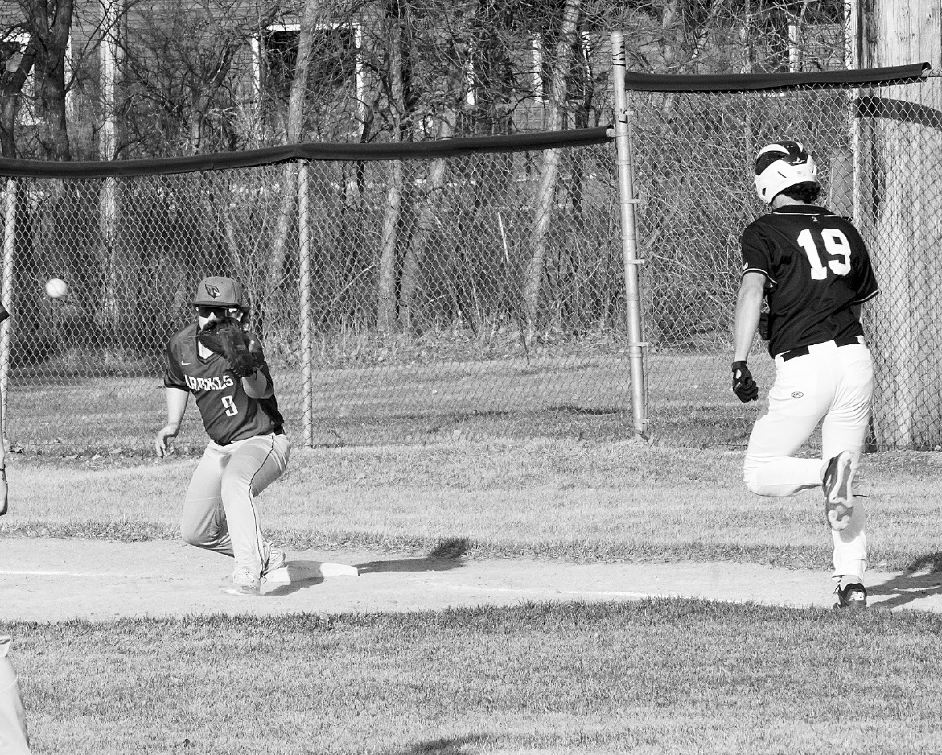 Devin Hakanson waits for the ball and puts out the Aggie player. Photo by Larry Stokke.