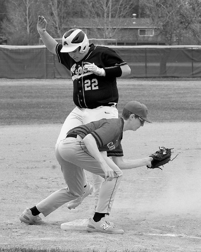 Sam Davis with a catch and an out against the Aggies. Photo by Larry Stokke.