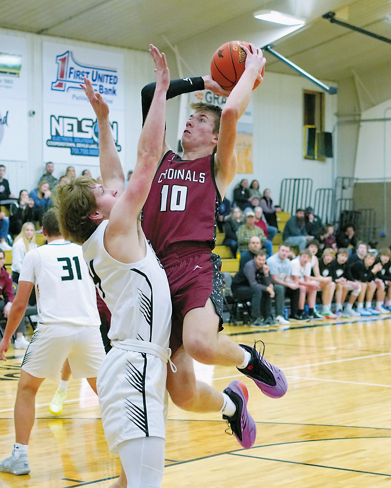Maddux Stremick eyes the rim and adds two points to the Cards' score. Photo by Larry Stokke.