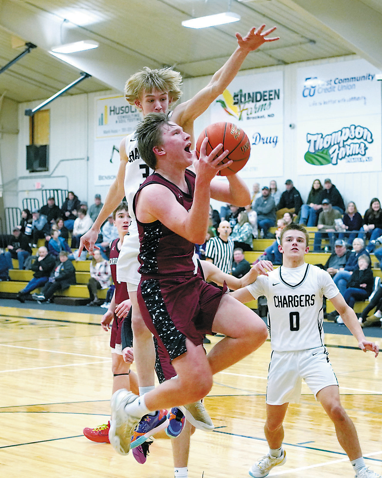 Levi Swanson drops in a bucket under pressure in the Cards' win in Lakota on Jan. 13. Photo by Larry Stokke.