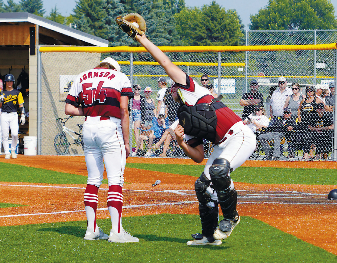 Landon Schneider catches a high pop fly for an out against Park River. Photo by Larry Stokke.