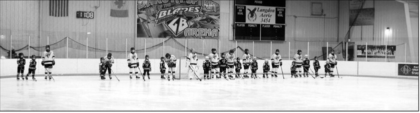 Players with their little buddies at the start of the game. Photo by Larry Stokke