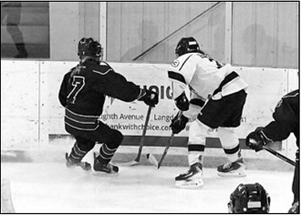 Hayden Balsdon fights for control of the puck when the Blades beat Bottineau 3-2 on Jan. 25. Photo by Larry Stokke