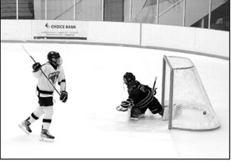 Colby Forest sends the puck past the Bottineau goalie, scoring one of her two goals in the win for the Lady Blades at the Dakota Spirit Arena Jan. 25. Photo by Larry Stokke