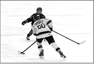 McKenzie Regner brings the puck up the ice and eventually scored a goal for the Blades. Photo by Larry Stokke