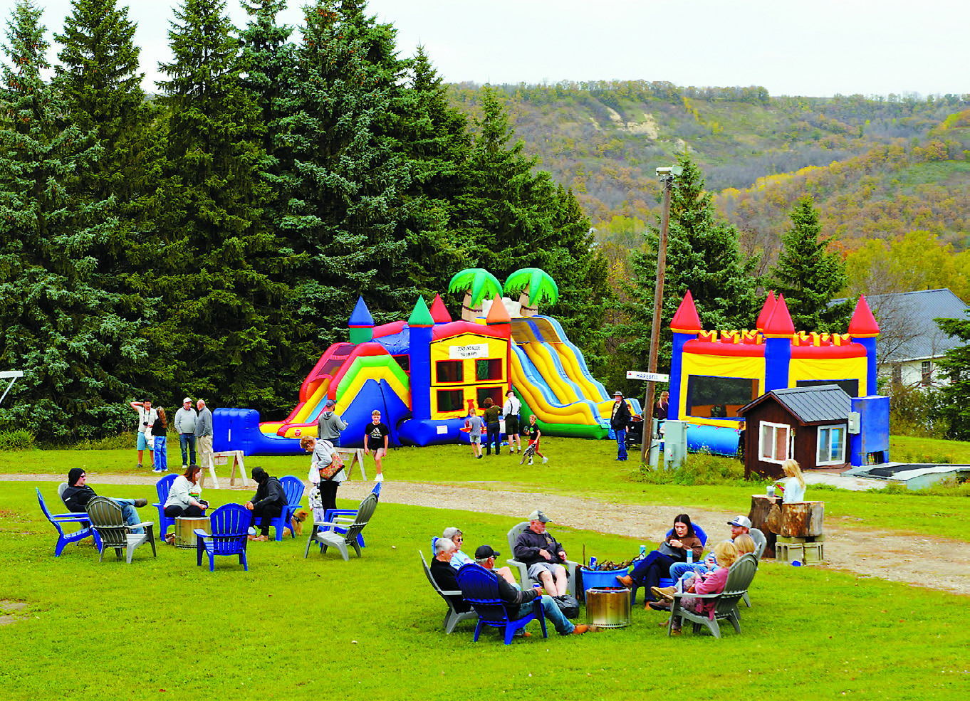 Children enjoyed a variety of bounce houses while the adults sat by the fire pits at Oktoberfest. Photo by Larry Stokke.