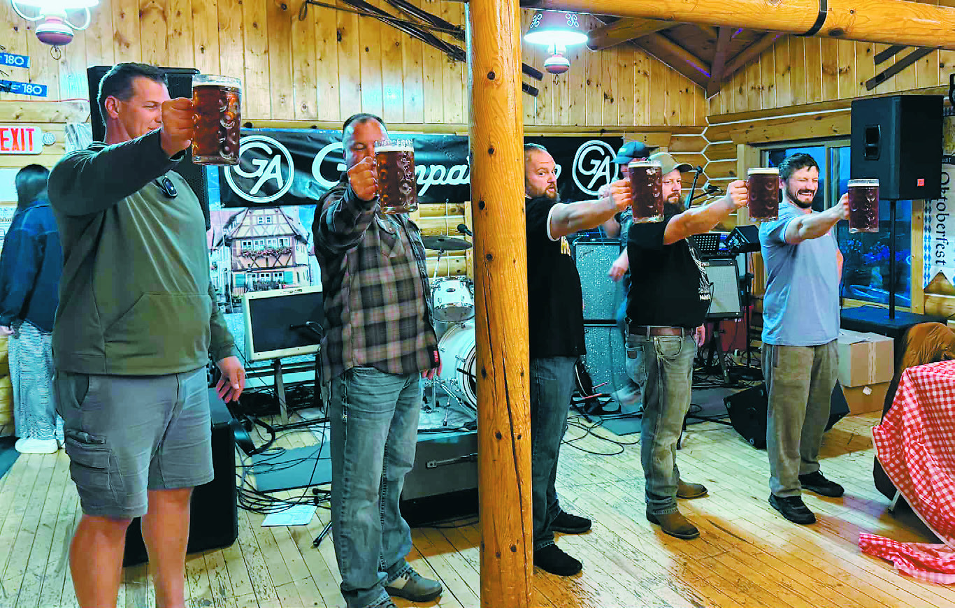 Men competing in the Stein Holding Contest at Frost Fire’s Oktoberfest - prost! Photo by Julie Regner.
