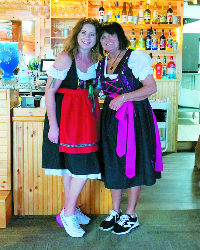 Julie Regner and Anita Mathison working hard during Oktoberfest. Photo by Larry Stokke.