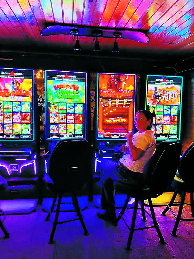 An Oktoberfest attendee sits at one of Frost Fire’s newly added gaming machines. Photo by Julie Regner.