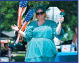 Dressed as the Statue of Liberty, a parade participant waves to the crowd during Pembina’s Fourth of July celebration. Photo by Ashley Schafer
