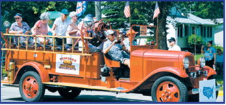 Pembina alumni ride the town’s restored 1932 Model B fire truck during the Fourth of July parade and All-School Reunion celebration. Photo by Ashley Schafer