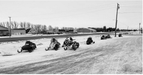 Snowmobiles are parked outside At the Hop in Langdon during the 2025 Fun Run event. Submitted photo