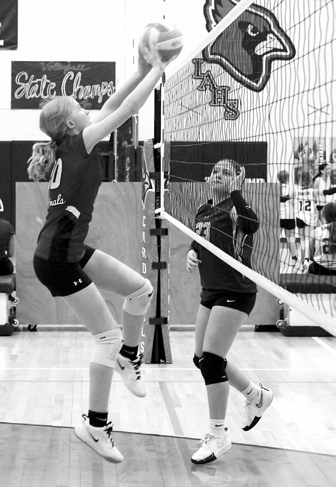 Maci Witzel tips the ball over the net for a win over the Grafton Spoilers April 14. Photo by Larry Stokke.