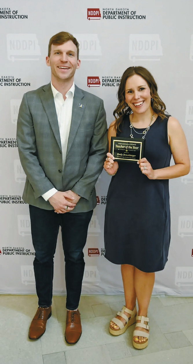 Emily Braunberger of Langdon, right, is recognized as the 2026 Cavalier County Teacher of the Year by North Dakota Superintendent of Public Instruction Levi Bachmeier during a ceremony in Bismarck. Submitted phot