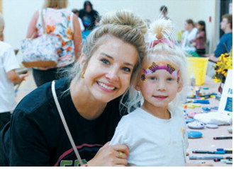 Executive Director of the LPH foundation, McKinzie Sivertson, and her daughter Daisy take a moment out of the fun to pose for a photo. Photo by Larry Stokke
