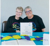 Patricia Scott and Mary Kuchar take a shift to greet the community members as they sign the guest book. Photo by Larry Stokke