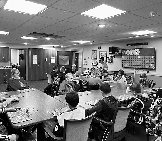 Students playing bingo with residents.