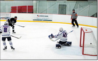Ty Ramberg sent the puck into the net and had a hat trick over Richland. Ty had 8 goals for the weekend. Photo by Larry Stokke..