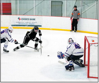 Keaton Ullyott fires a shot at the Richland net on Jan. 11th in Langdon. Photo by Larry Stokke.