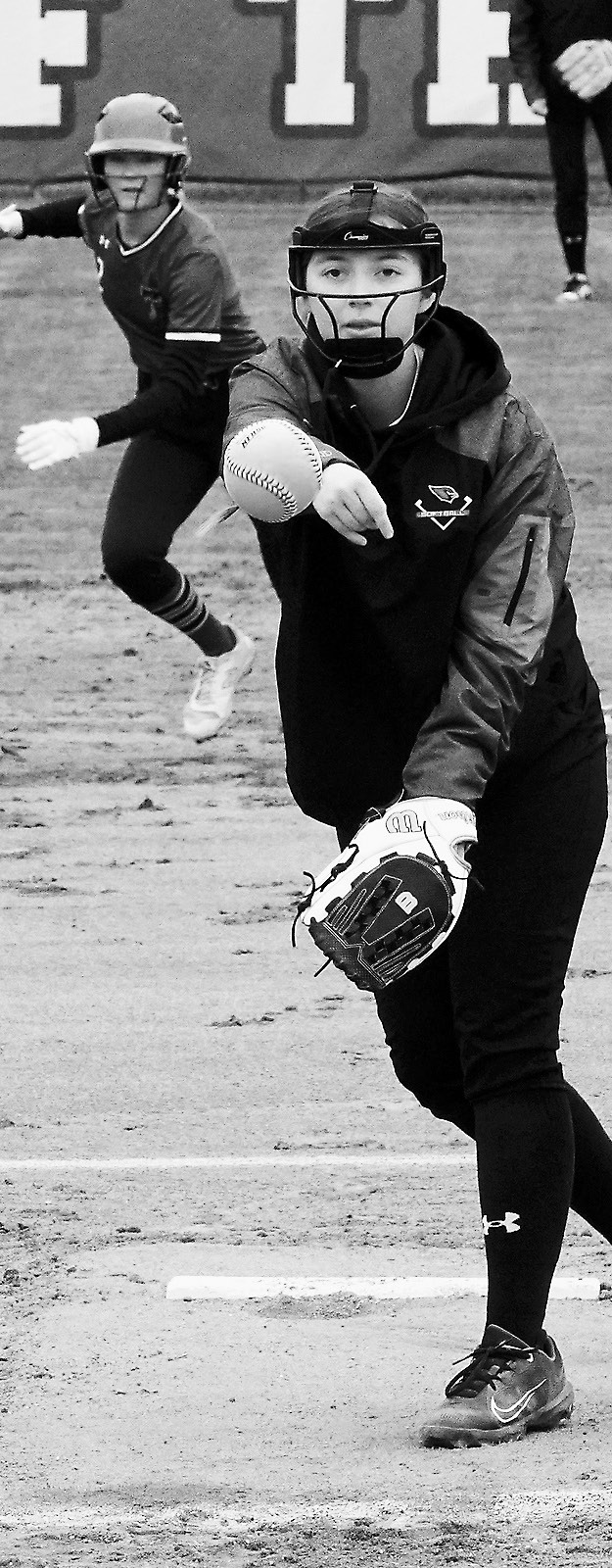 Nadia Lewis sends a strike over the plate in the Cards' game against the Tommies. Photo by Larry Stokke.