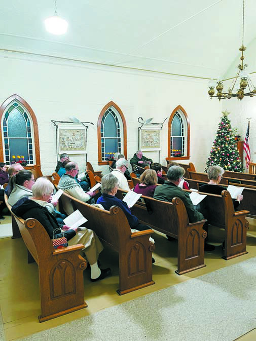 Attendees filled the pews last year for the Carol Sing at the beautifully decorated Hallson Church.