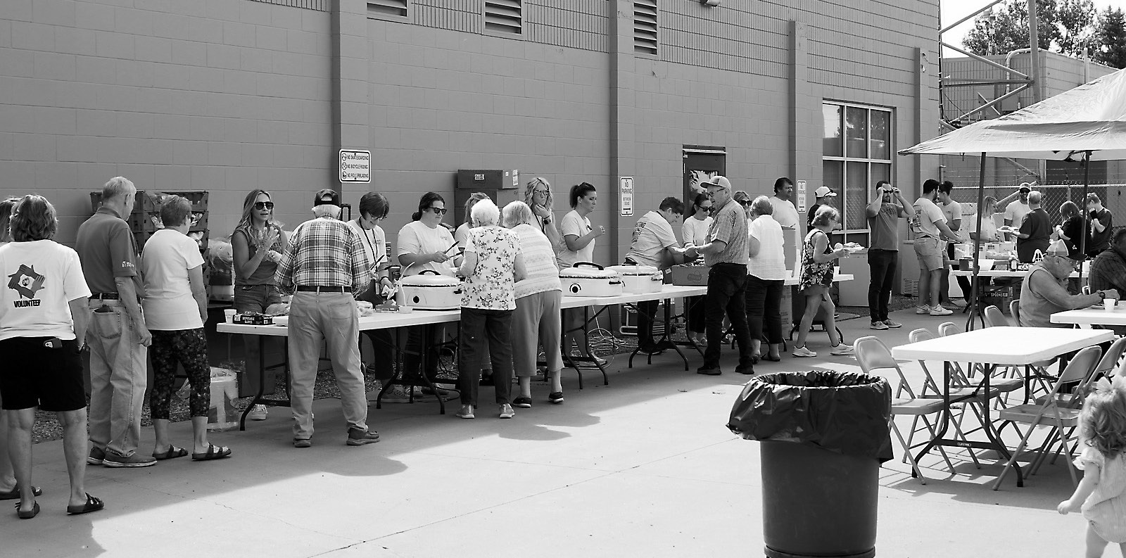 Folks line up for the free meal provided by United Communications last week. Photo by Larry Stokke.