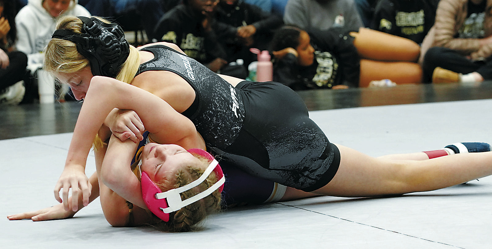 Maci Puppe in the 100 lb weight class pins her opponent. Photo by Larry Stokke.