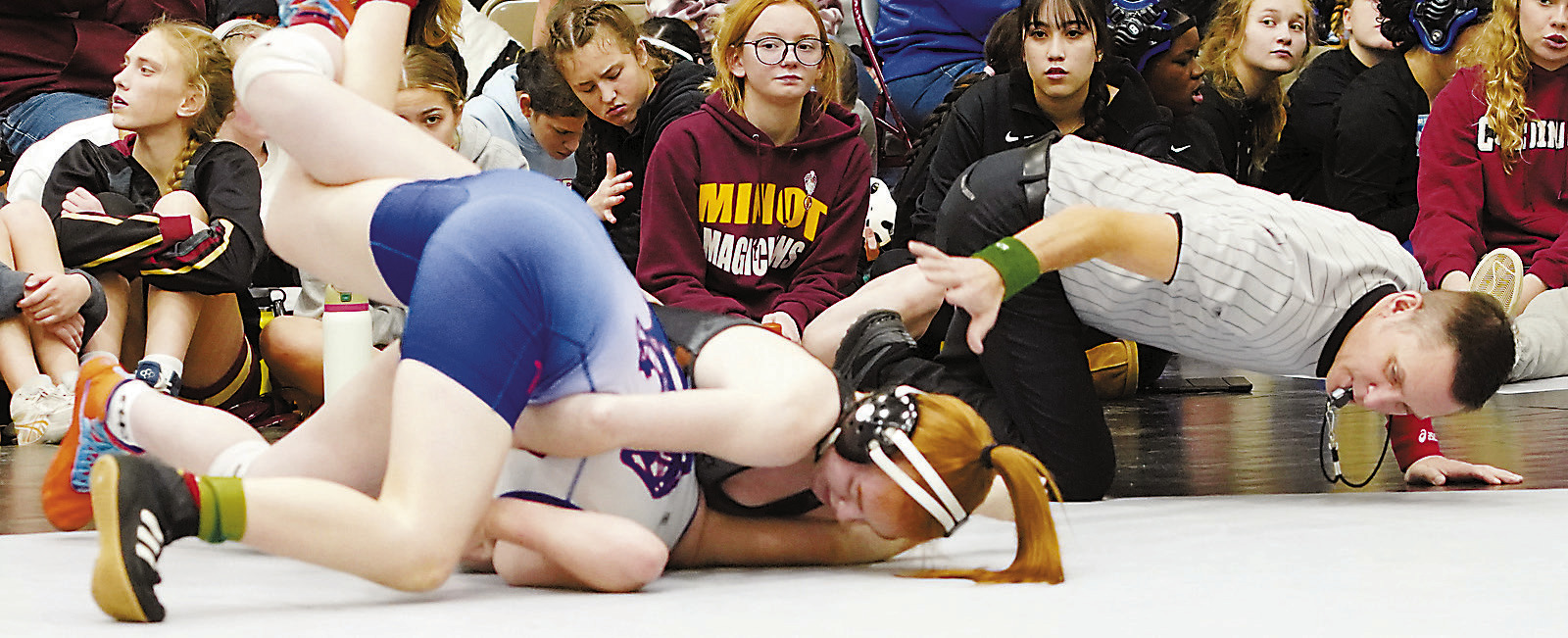 Marlie Stremick pins her opponent in Grand Forks on Dec. 14. Photo by Larry Stokke.