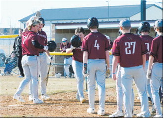 Theo Romfo gets high-fives after he hit his second home run of the season. Theo was 3 for 5 with a homer and 2 RBIs. Photo by Larry Stokke