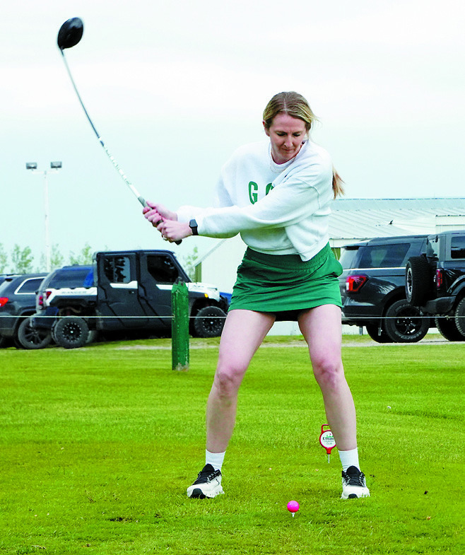Katelyn Vesterso eyes the ball and swings hard, bending her club as she tee's off on Saturday, June 7 at the LPH Foundation Tournament. Photo by Larry Stokke.