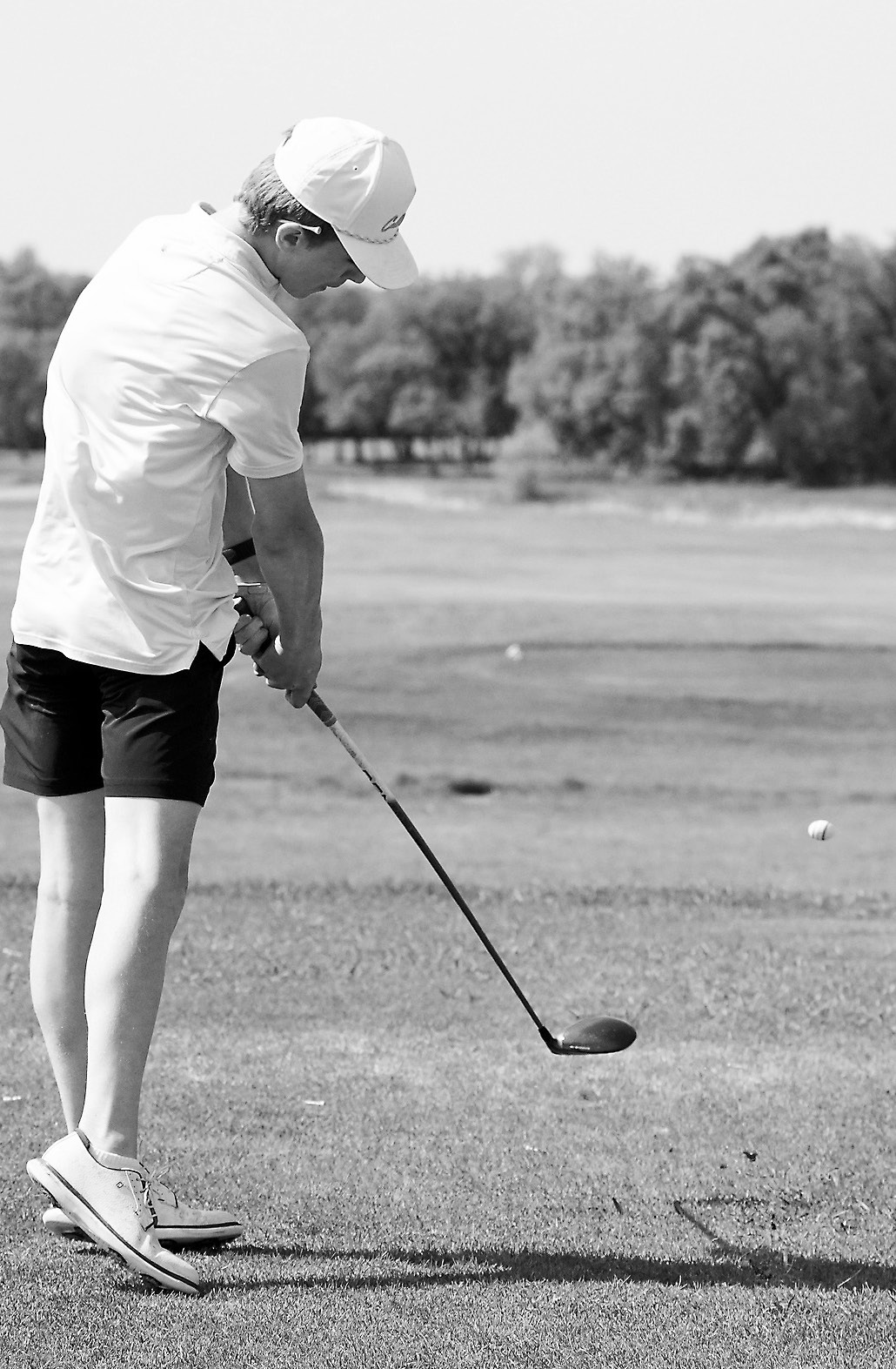 Ryder Moser tees off at the Regional Golf Meet in Devils Lake on May 27 and will head to the State Golf Meet. Moser finished in the top 10 and made the All-Region 3 Team. Photo by Larry Stokke.