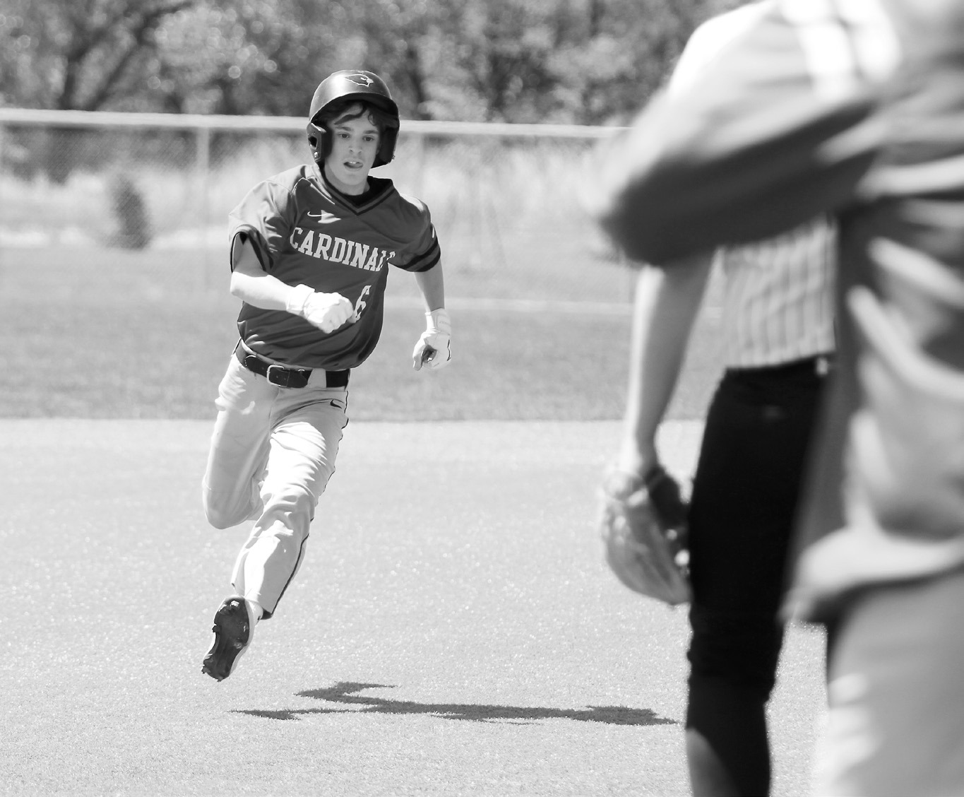 Connor Mitchell rounds the base and gets safely on. Photo by Chelsea Wysocki/The Walsh County Record.