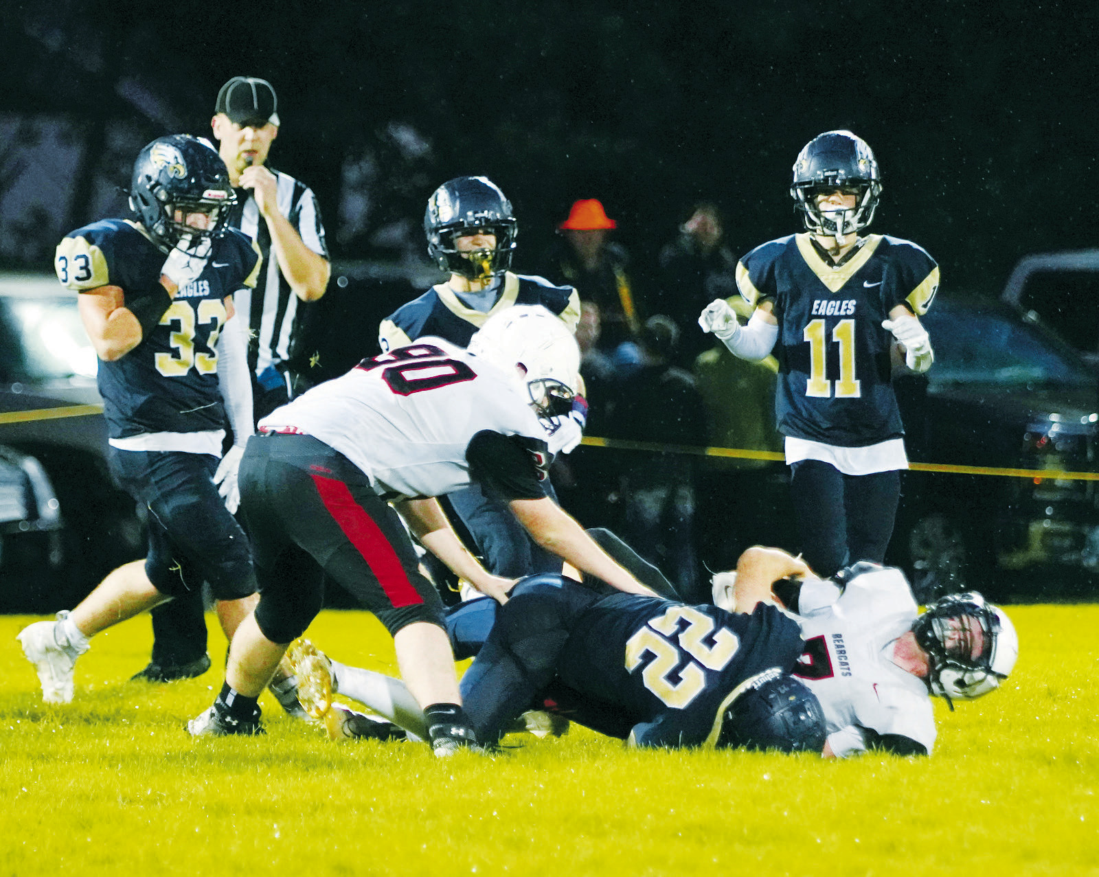 Zeke Symington tackles Bearcat Sean Freund. Photo by Larry Stokke.
