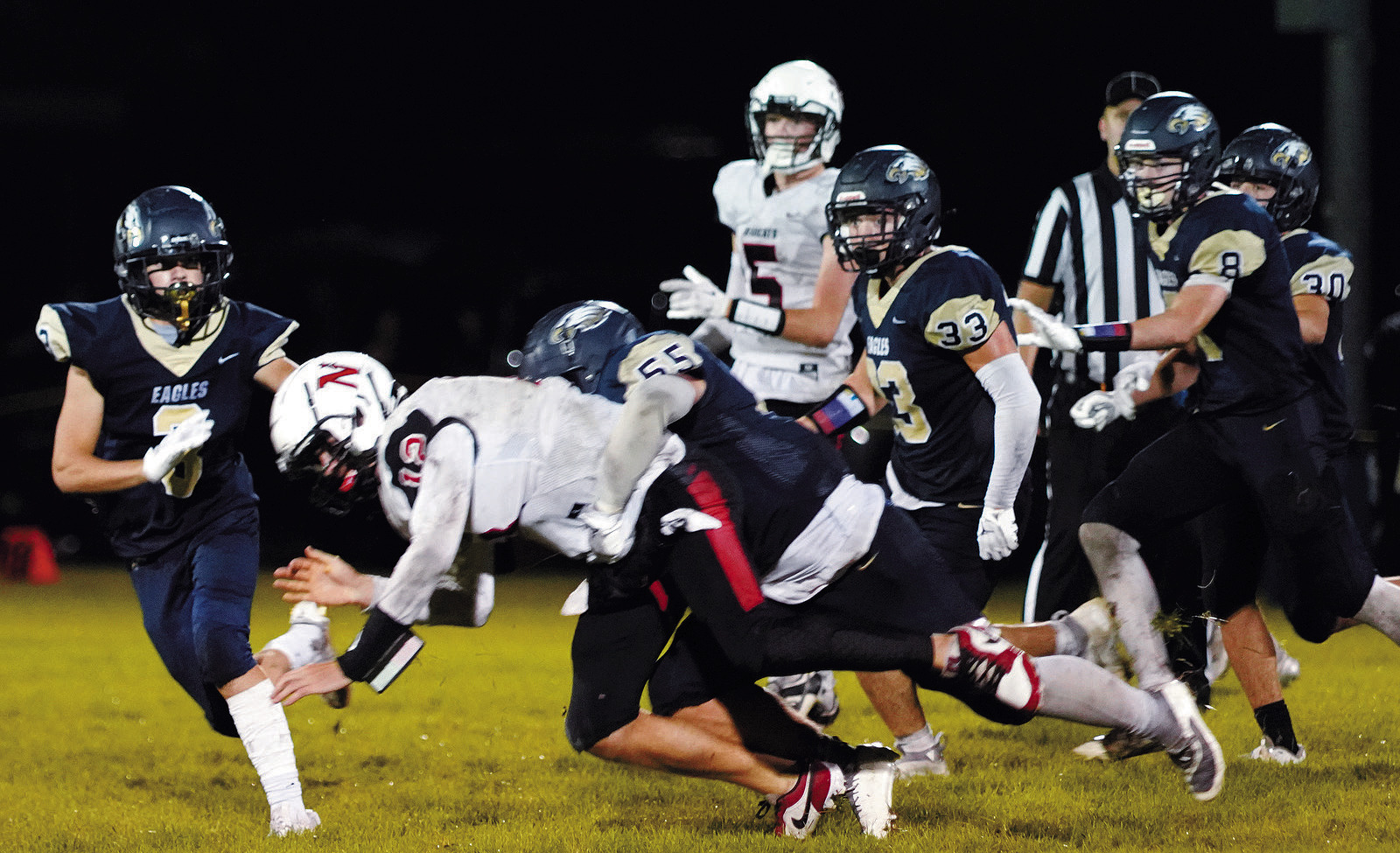 Gavin Symington tackles Bearcat Hunter Hagler in the Eagles win over North Star. Photo by Larry Stokke.