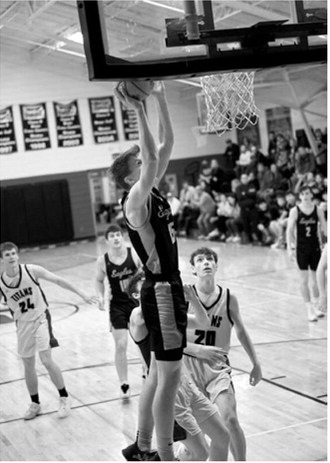 Garret Willits receives the pass from Colton Bailly and lays it in for a basket. Photo by Ashley Schafer